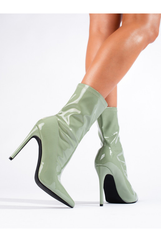 Women's boots on a high heel made of patent ecological leather green