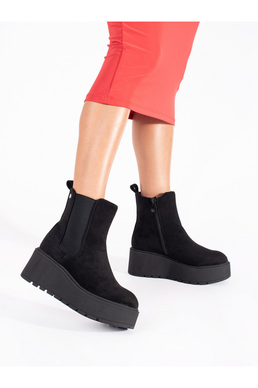 black of suede Chelsea boots on a wedge