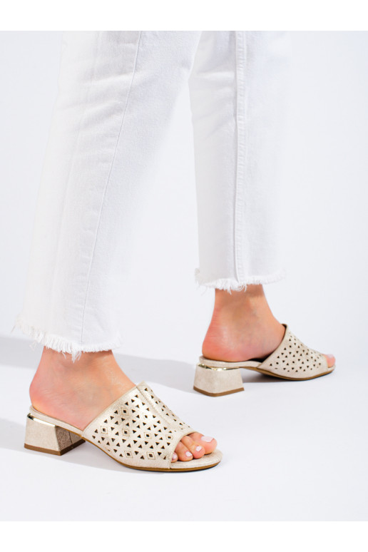 Openwork gold-colored slippers with a low heel